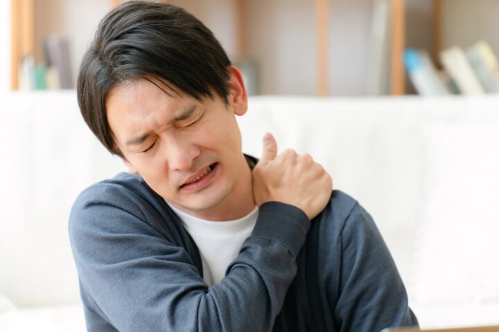 肩こりで肩が痛い男性